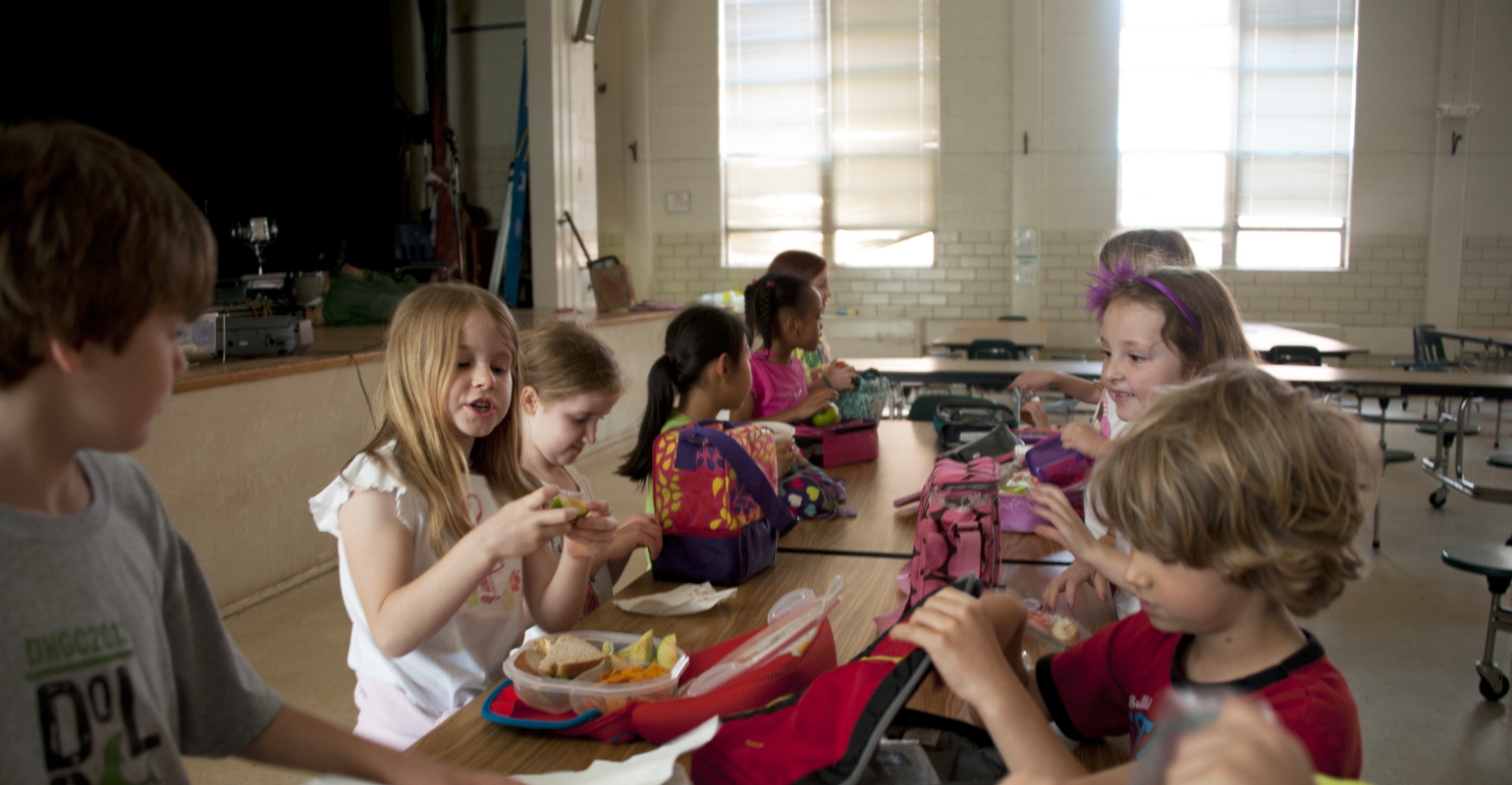 An image of children eating lunch at the school table